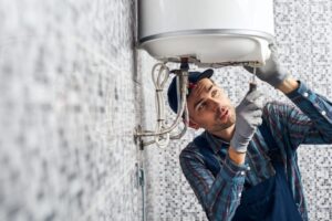 almost-done-worker-set-up-electric-heating-boiler-at-home-bathroom.jpg